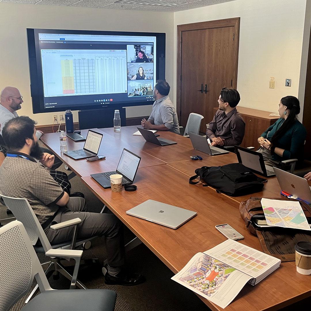 Planning staff reviewing code on a video conference